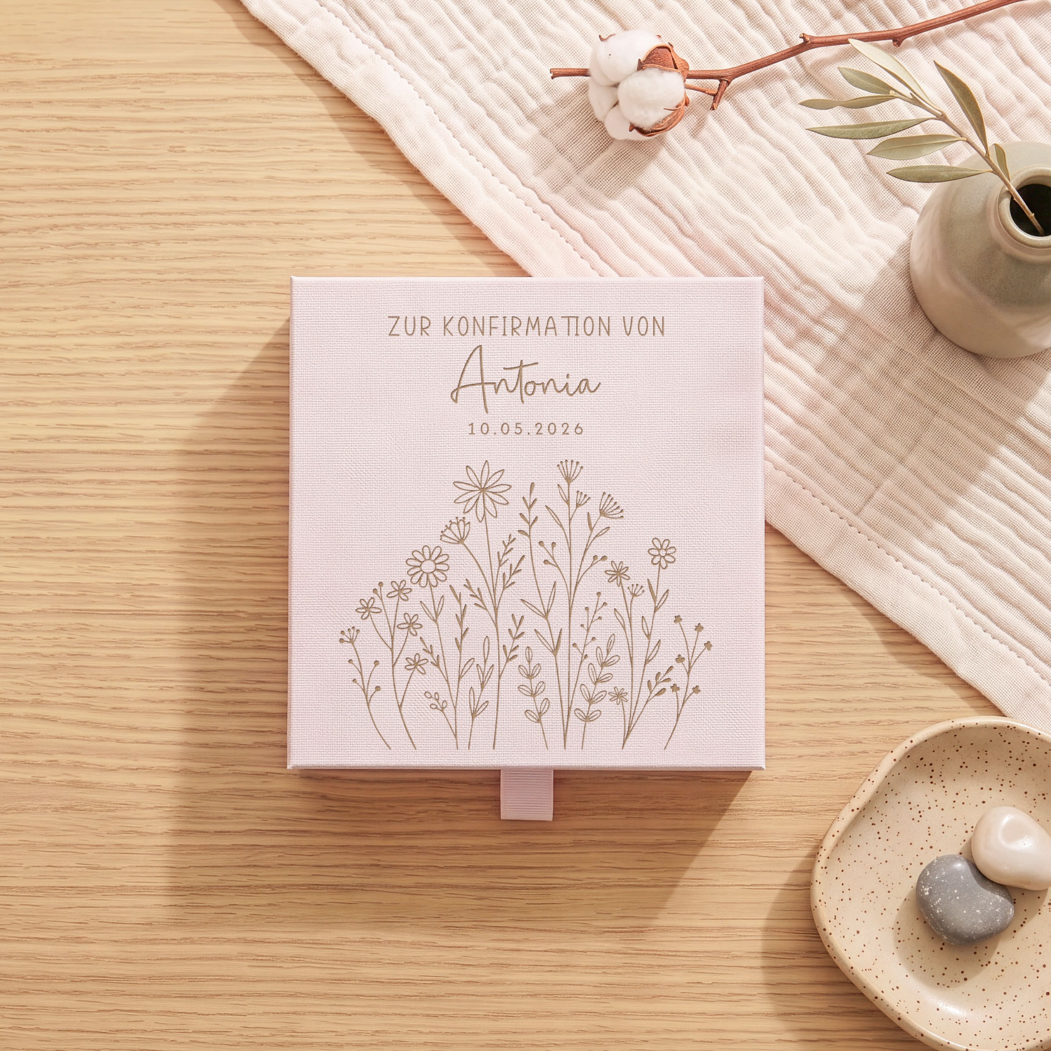 Personalisierte rosa Geschenkbox aus Karton zur Konfirmation. Der Deckel zeigt eine Lasergravur mit filigraner Blumenwiesen und Platz für Namen und Datum.